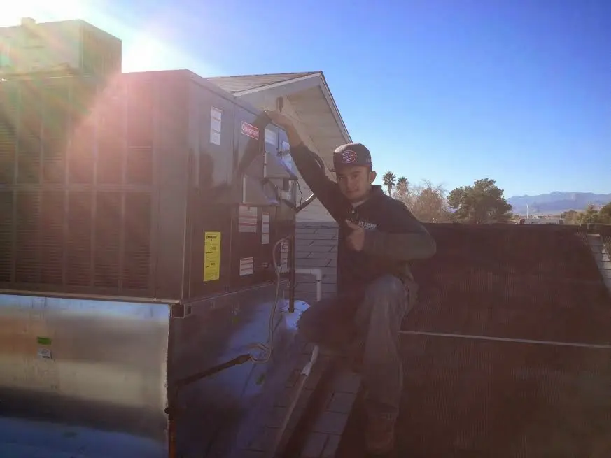 HVAC technician performing Air Duct Repair on a rooftop unit in Sierra Vista Southeast